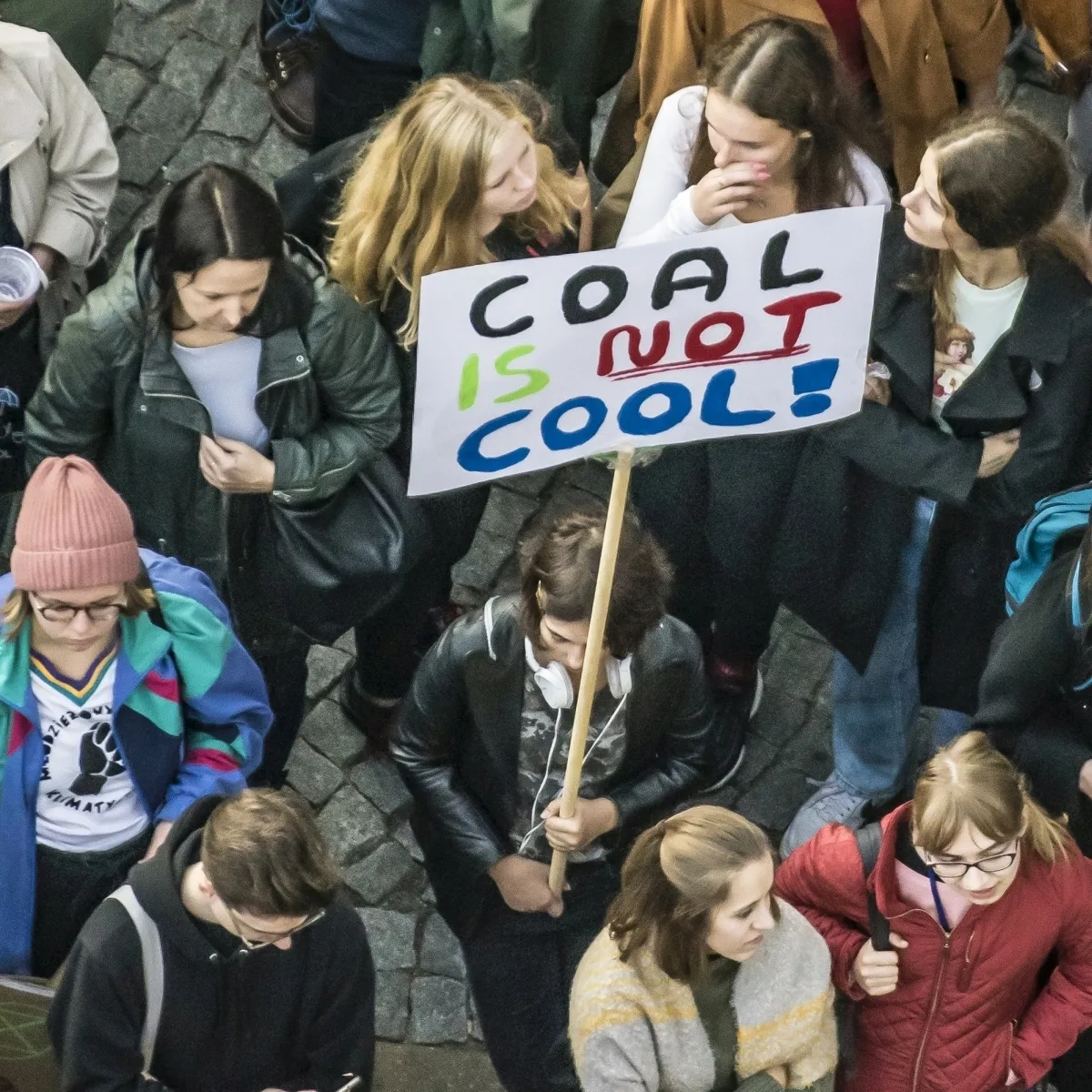 Young protesters holding a COAL IS NOT COOL sign